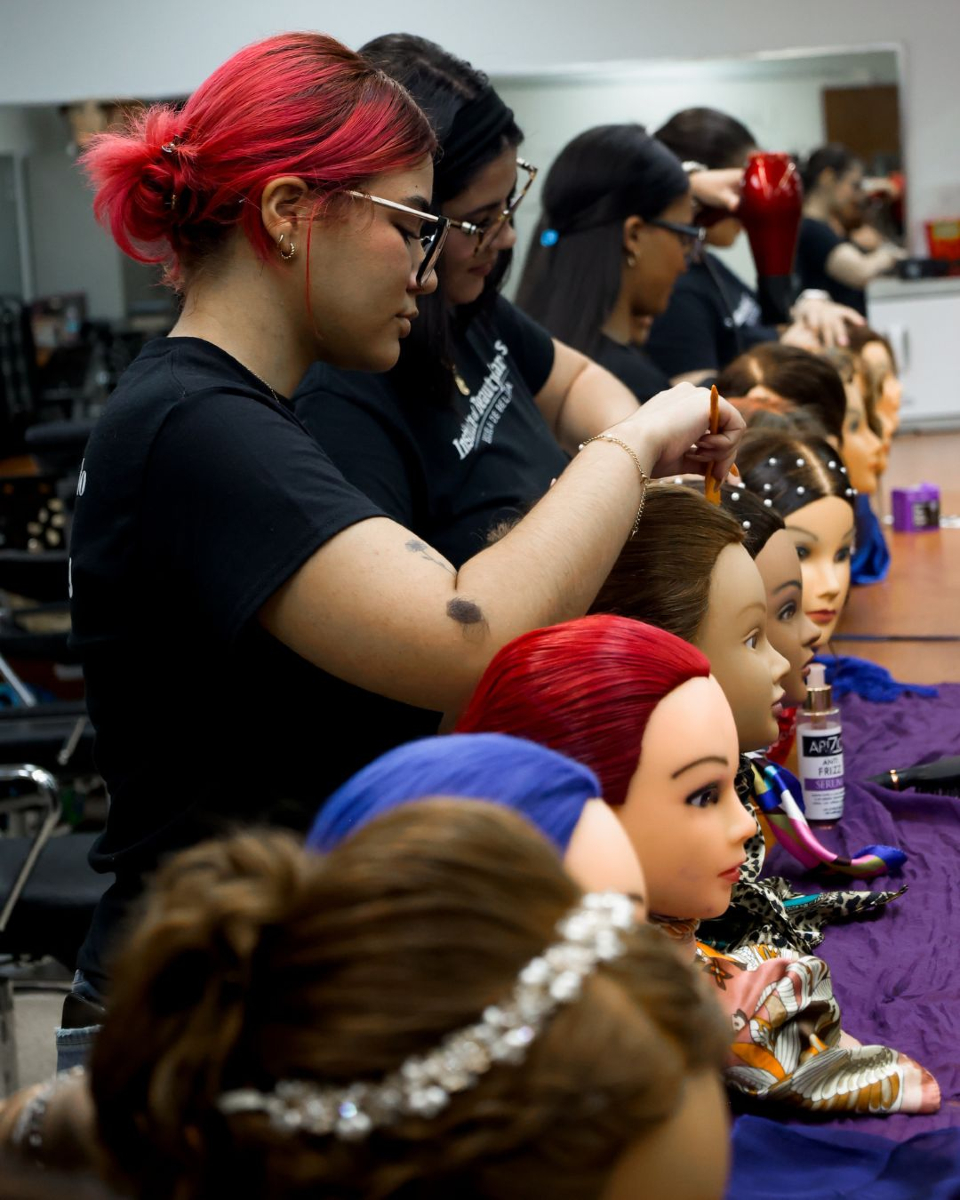 Estudiantes de cosmetología practicando técnicas en maniquíes
